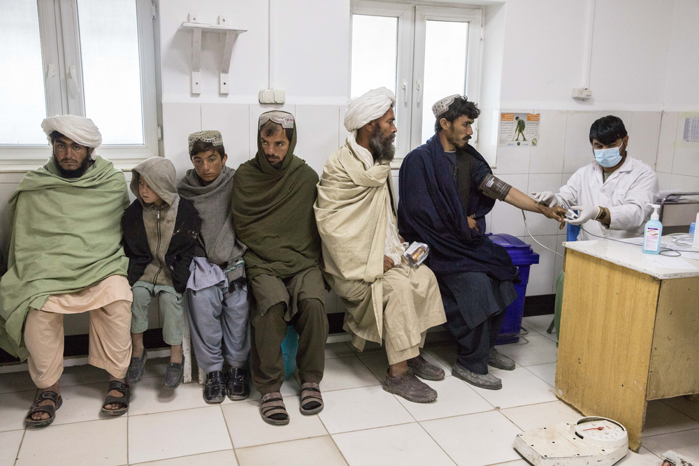Male Emergency <br> Male patients wait for an MSF nurse to take their vital signs in the triage area of the emergency room.