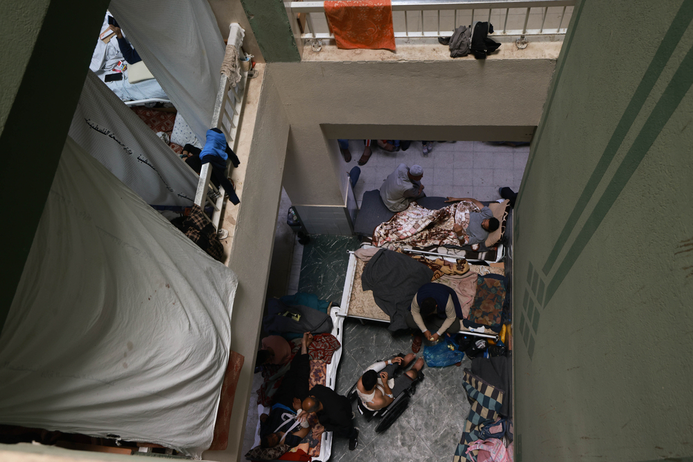 An above view of a crowded hallway at Al-Aqsa hospital, where patients and displaced people are forced to live. © MOHAMMED ABED
