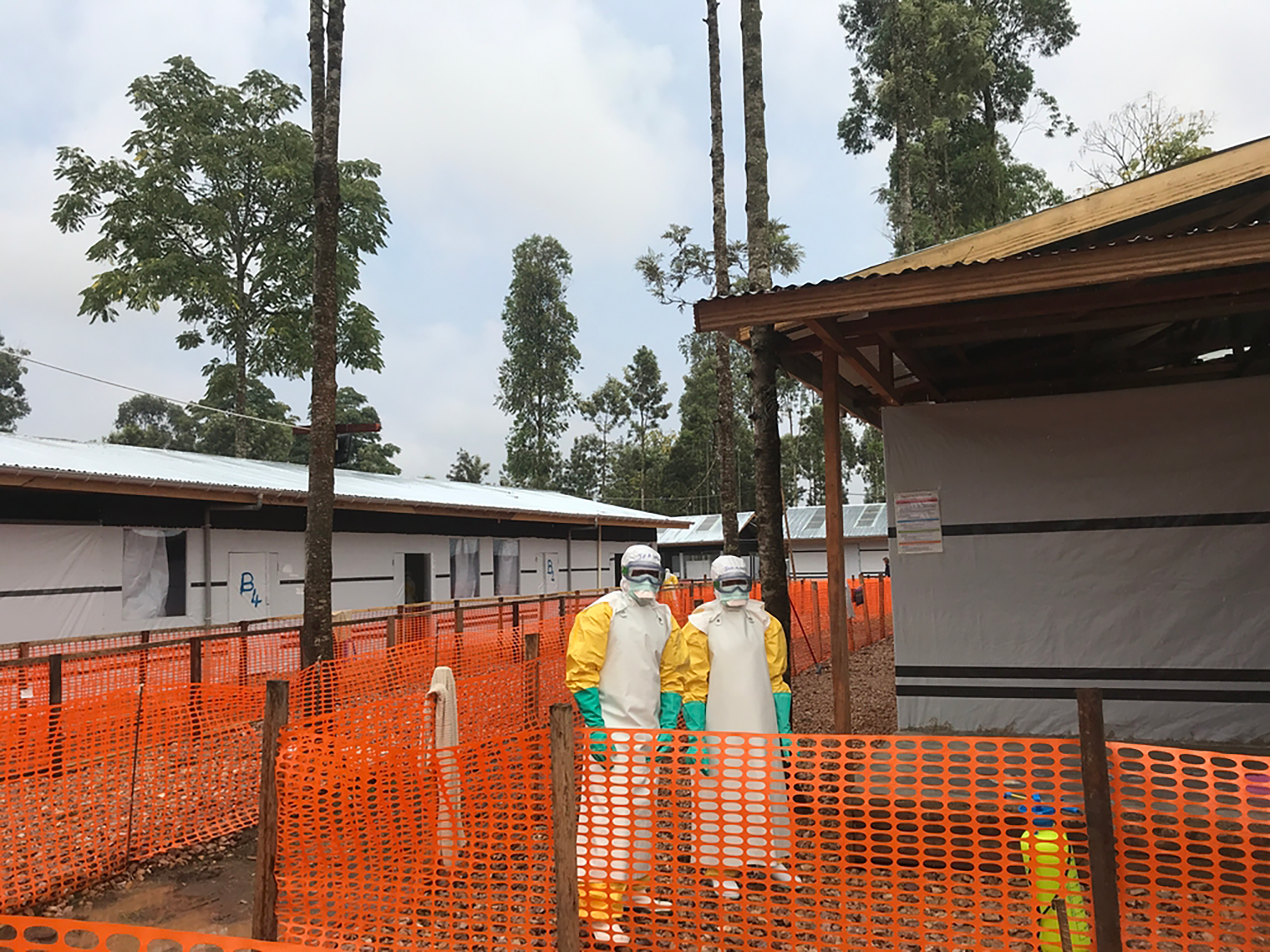 Two staff in full personal protective equipment wait for a person suspected of having Ebola at the newly-opened MSF Ebola Treatment Centre in Katwa, North Kivu province, Democratic Republic of Congo. © Lisa Veran/MSF 