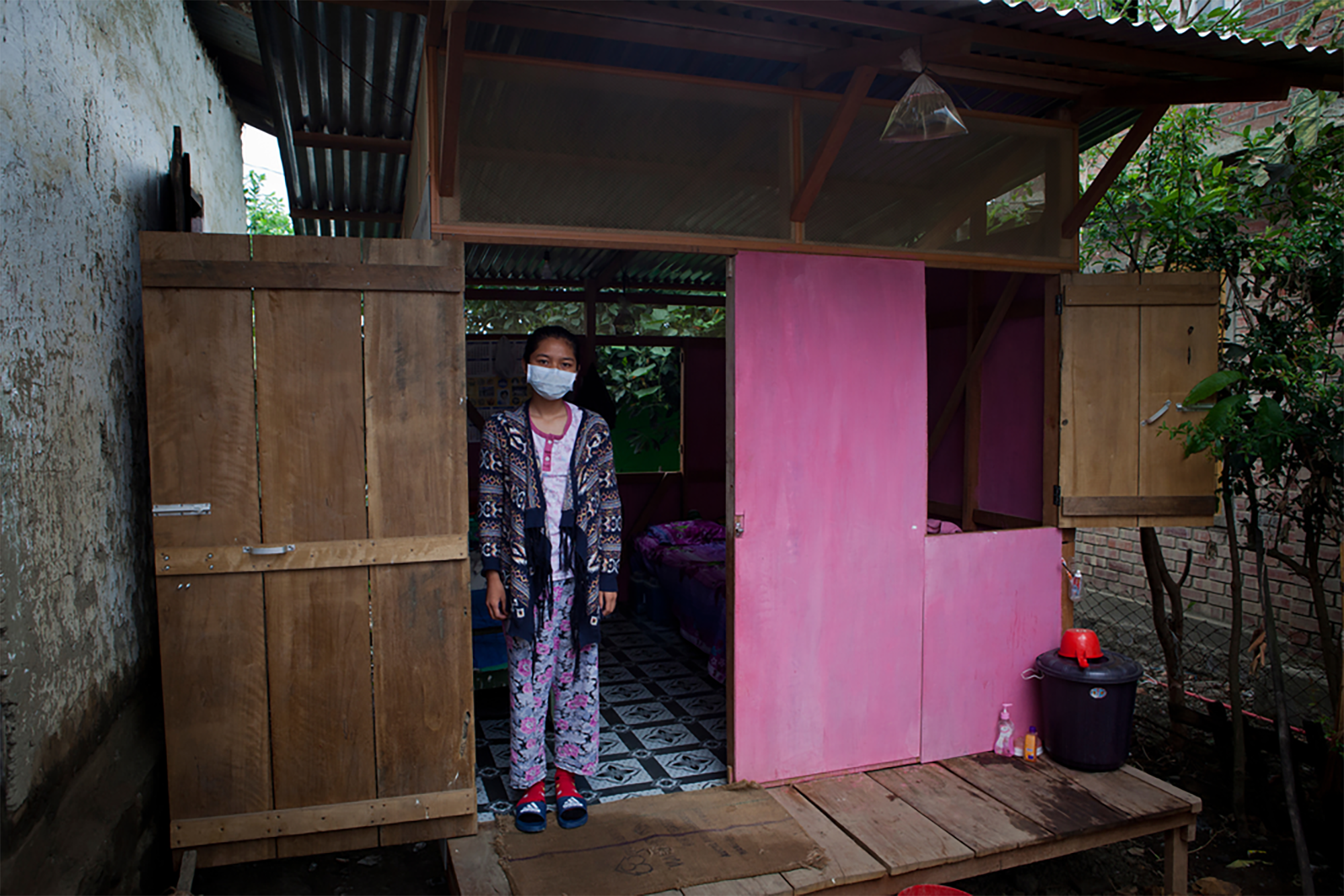 Grace Siemtharmawi, 17, is an MDR-TB patient. She stands in the door of the small house MSF built her next to her family home. © Jan-Joseph Stok 