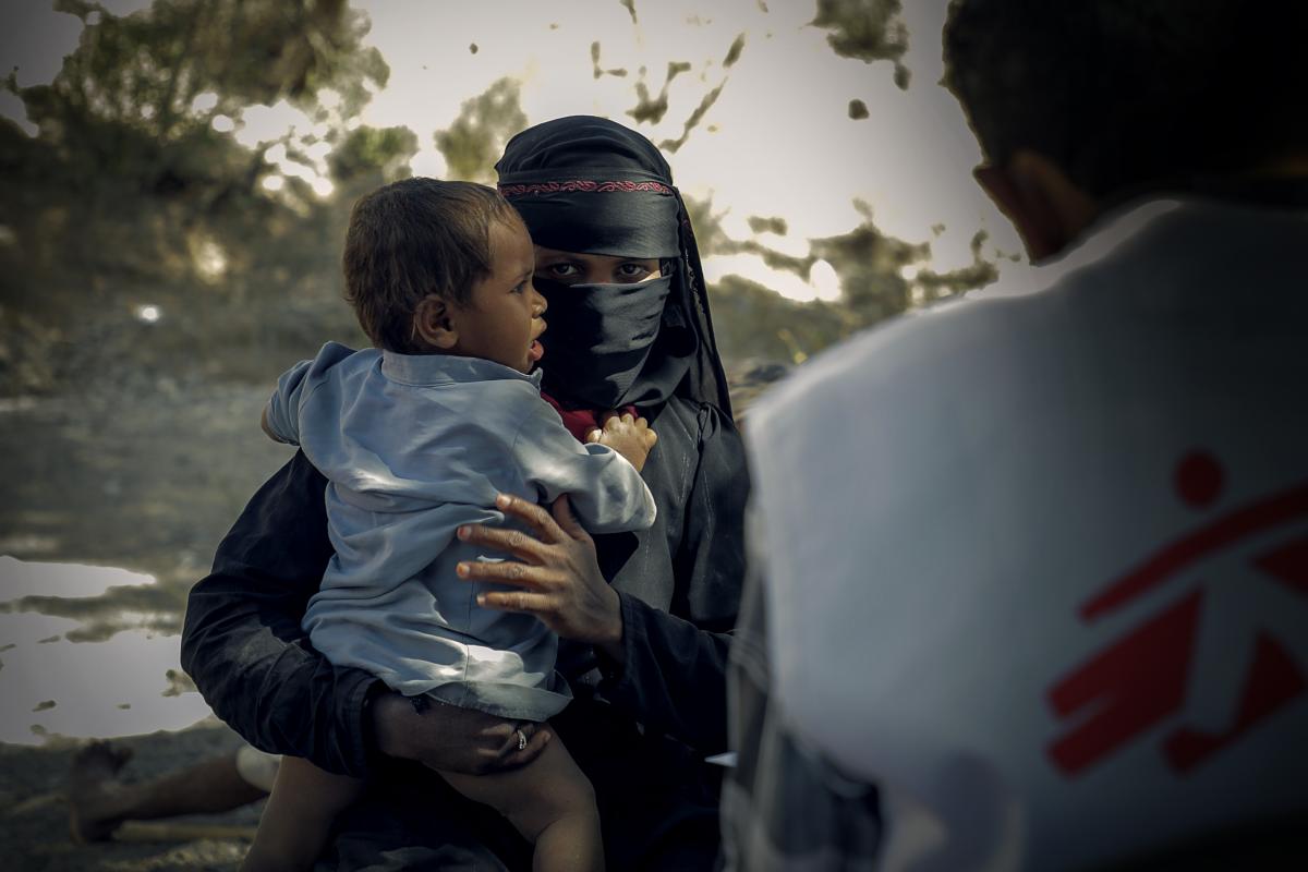 A mother takes her son to MSF's mobile clinic for a regular health checkup. ©MSF